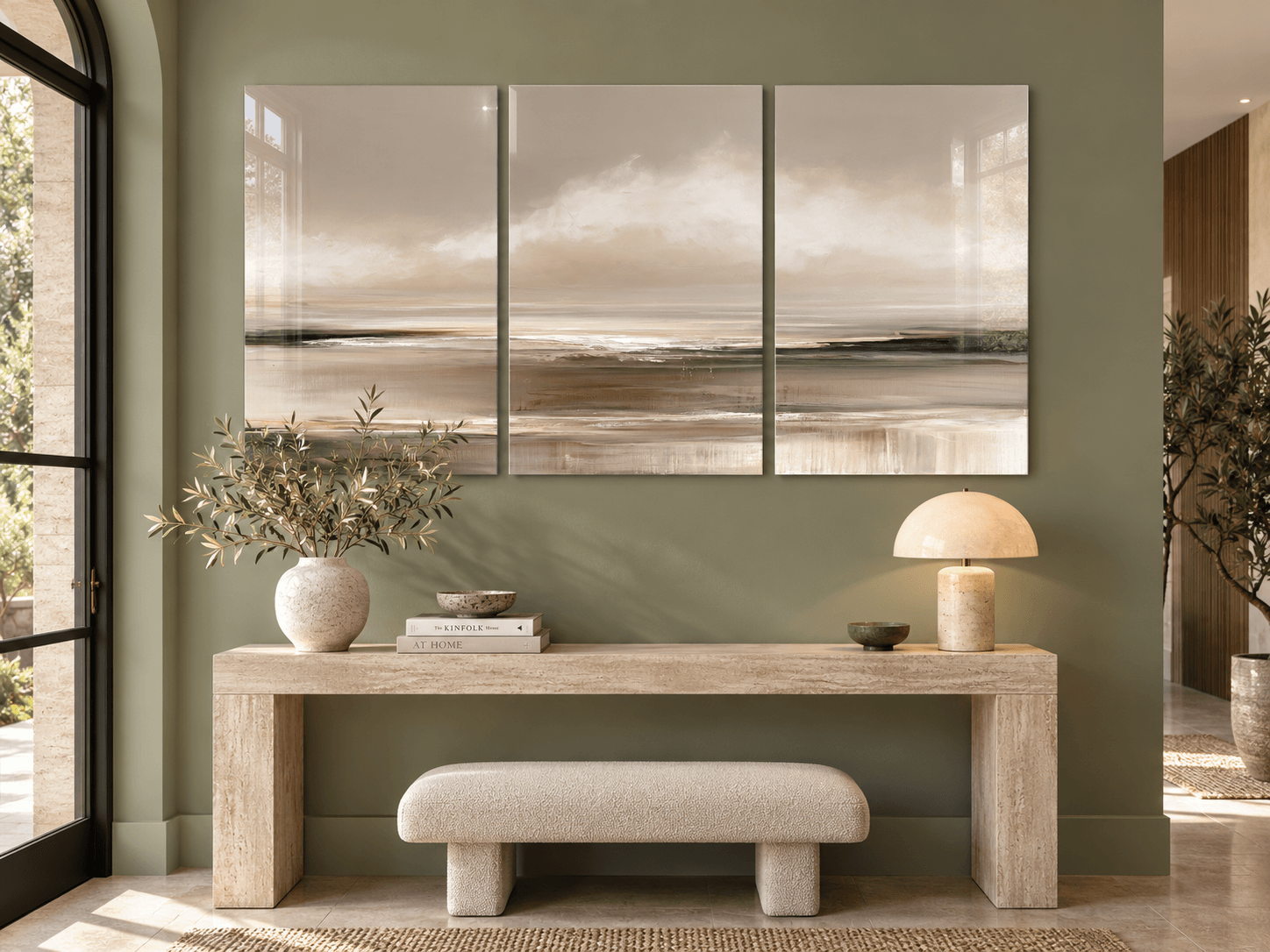 Triptych coastal horizon glass wall art above a travertine console in a sage-green entryway